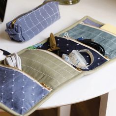 an open zippered pouch sitting on top of a white table next to a computer