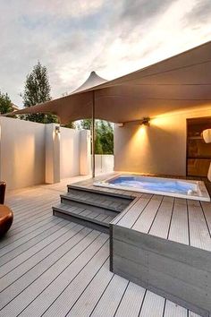 a hot tub sitting on top of a wooden deck