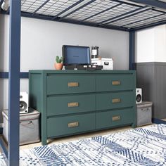 a bed room with a dresser and a computer