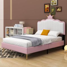 a bedroom with a pink bed and white furniture