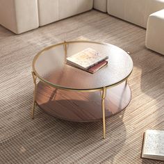 a coffee table sitting on top of a carpeted floor next to a white couch