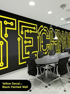 a conference room with black and yellow graphics on the wall