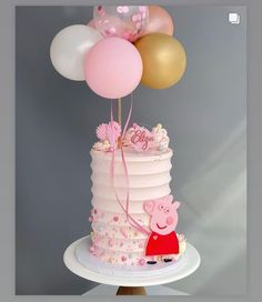 a pepo pig cake with balloons on top is shown in front of a gray background