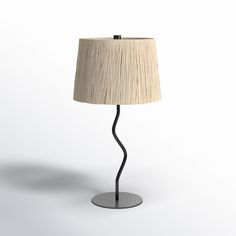 a lamp that is on top of a metal base with a light shade over it