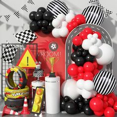 a room filled with balloons and decorations on top of a table next to a wall