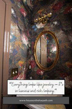 a bathroom with a mirror and flowers on the wall