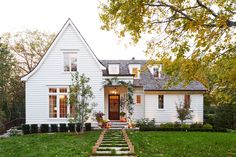 a white house with steps leading to the front door