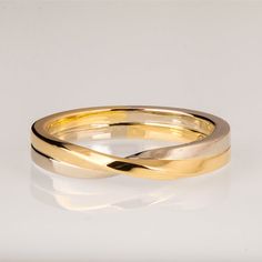 two gold wedding bands on a white background