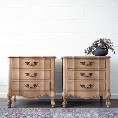 two wooden dressers sitting next to each other on top of a rug