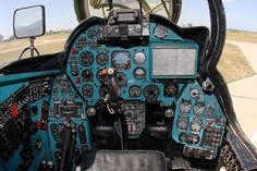 the cockpit of an airplane with many instruments