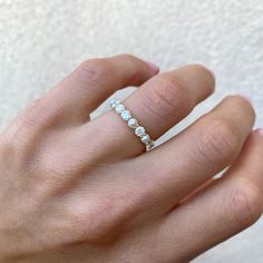 a woman's hand with a diamond ring on it