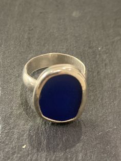 A hand made sterling silver ring set with a piece of cobalt blue coloured sea glass.  The sea glass is set into a fine silver bezel mounted on a sterling silver Band . The band is a 5mm half circle profile band..The ring is size a smaller size, O or US size 7.25 Silver Rings Blue Stone, Adjustable Silver Ring With Sea Glass, Silver Recycled Glass Ring, Minimalist Nickel-free Blue Ring, Circle Profile, Sea Glass Rings, Sea Glass Ring, Sterling Silver Rings Set, Blue Stone Ring