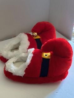 a pair of red slippers sitting on top of a white counter