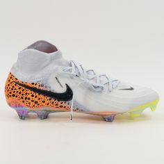 a pair of white and orange soccer shoes