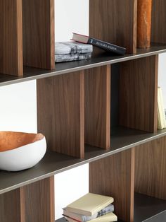 a bowl and some books on a shelf