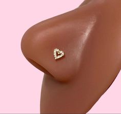 a close up view of the side of a woman's breast with a diamond heart on it