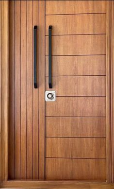 a wooden door with two black handles on the front and side doors that are made of wood