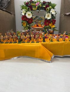 the table is covered with figurines and flowers