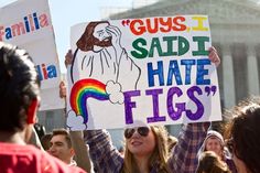 a woman holding up a sign that says guys, said i hate figs '