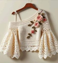 a crocheted top with flowers on it