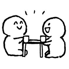 two people sitting at a table with their arms around each other