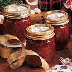 jars filled with jam sitting on top of a table