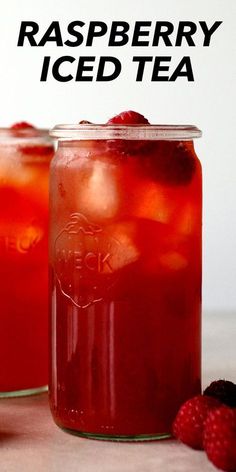 raspberry iced tea in mason jars with strawberries on the side and text overlay