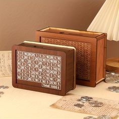 two wooden blocks with numbers on them sitting next to some silver coins and a lamp