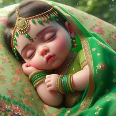 a baby doll dressed in green and gold laying on top of a blanket with its eyes closed