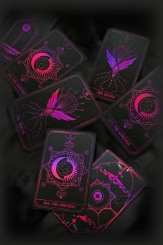 four tarot cards with neon lights on them, all in different shapes and sizes