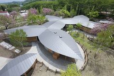 an aerial view of a building surrounded by trees