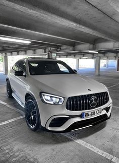 the mercedes benz amg coupe is parked in an empty parking garage with no one around