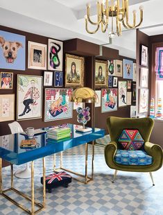 a living room filled with furniture and pictures on the wall next to a chandelier