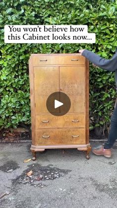 a woman standing next to a wooden cabinet with the words you won't believe how this cabinet looks now