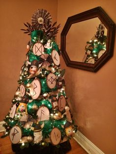 a christmas tree decorated with ornaments and mirrors