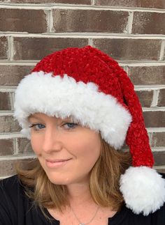 a woman wearing a red and white santa hat