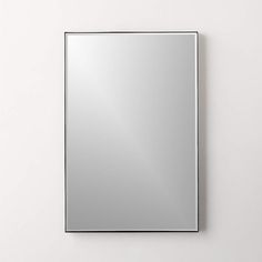 a square mirror mounted to the side of a wall