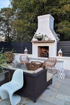 an outdoor fireplace and seating area in a backyard