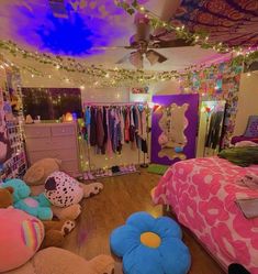 a bedroom decorated with stuffed animals and lights