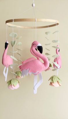 a pink flamingo mobile hanging from a ceiling