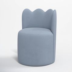 a blue chair sitting on top of a white floor