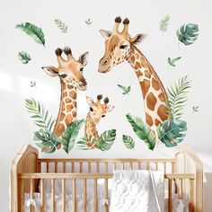 two giraffes standing next to each other in front of a baby crib