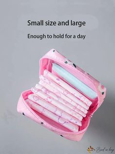 an open pink pencil case filled with pens