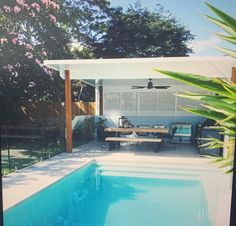 a pool with a table and chairs next to it