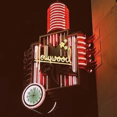 a neon sign with a clock attached to it