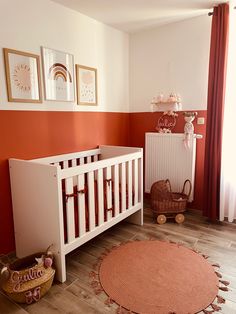 a baby's room with an orange and white theme