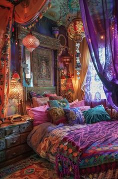 a bed covered in lots of colorful pillows and blankets next to a window with curtains