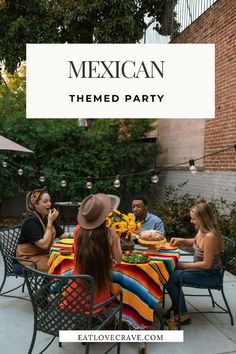 a group of people sitting around a table with food on it and the words mexican themed party