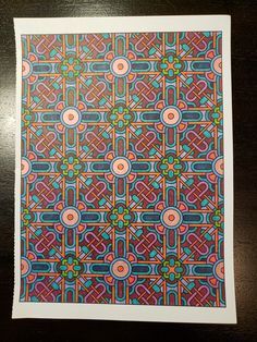 an intricately designed paper with circles and dots in blue, pink, orange and green