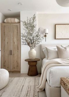 a bedroom with white walls and neutral decor